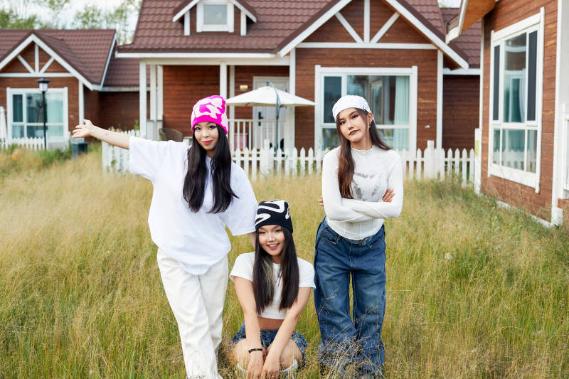 在旅游景区民宿外游玩拍照的三个姑娘们图片