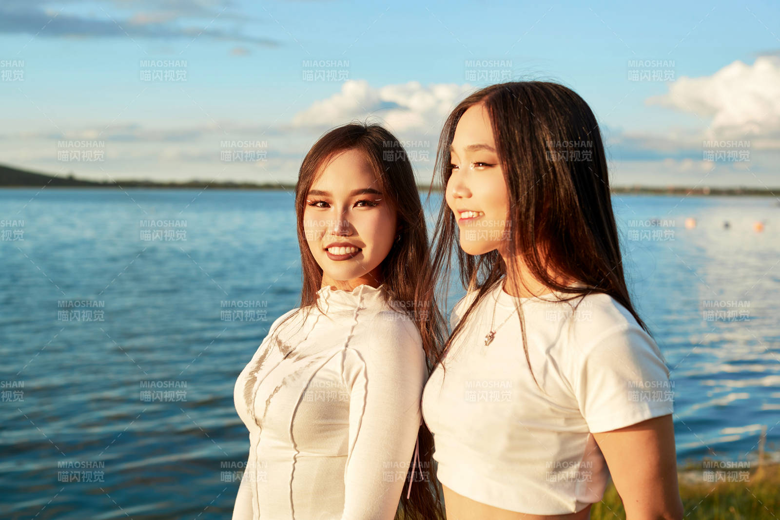 在旅游区湖边打卡点拍照的美女闺蜜图片