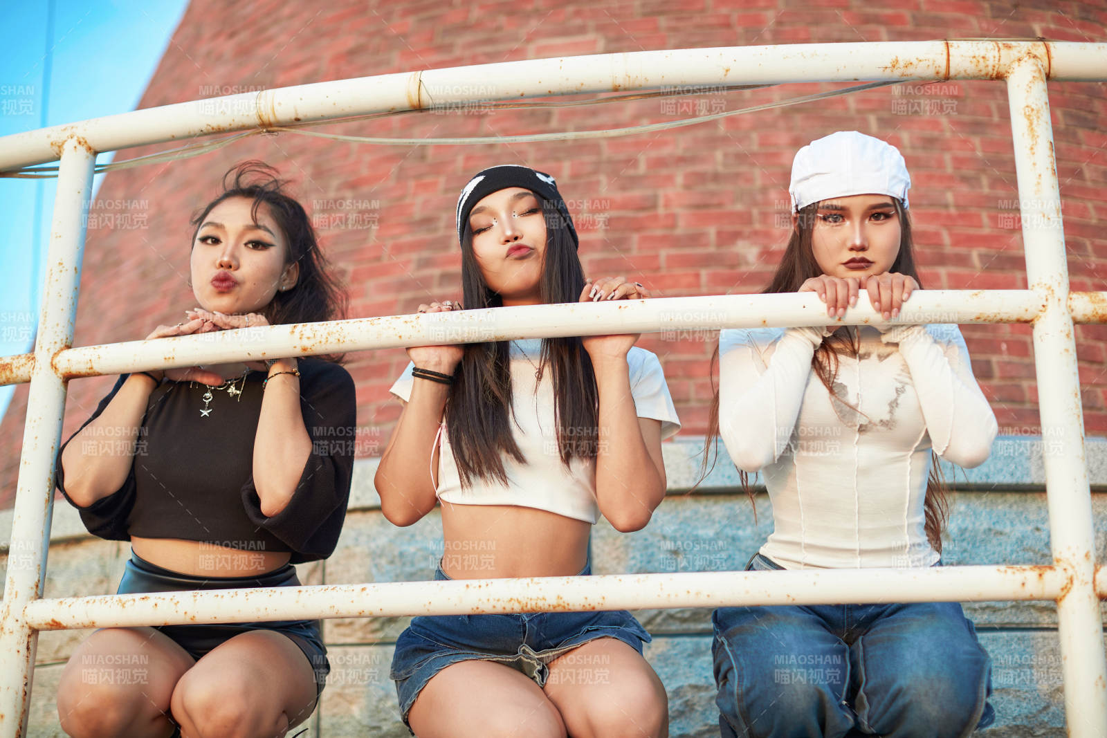 盛夏在草原湖边灯塔上拍照游玩的姑娘们图片