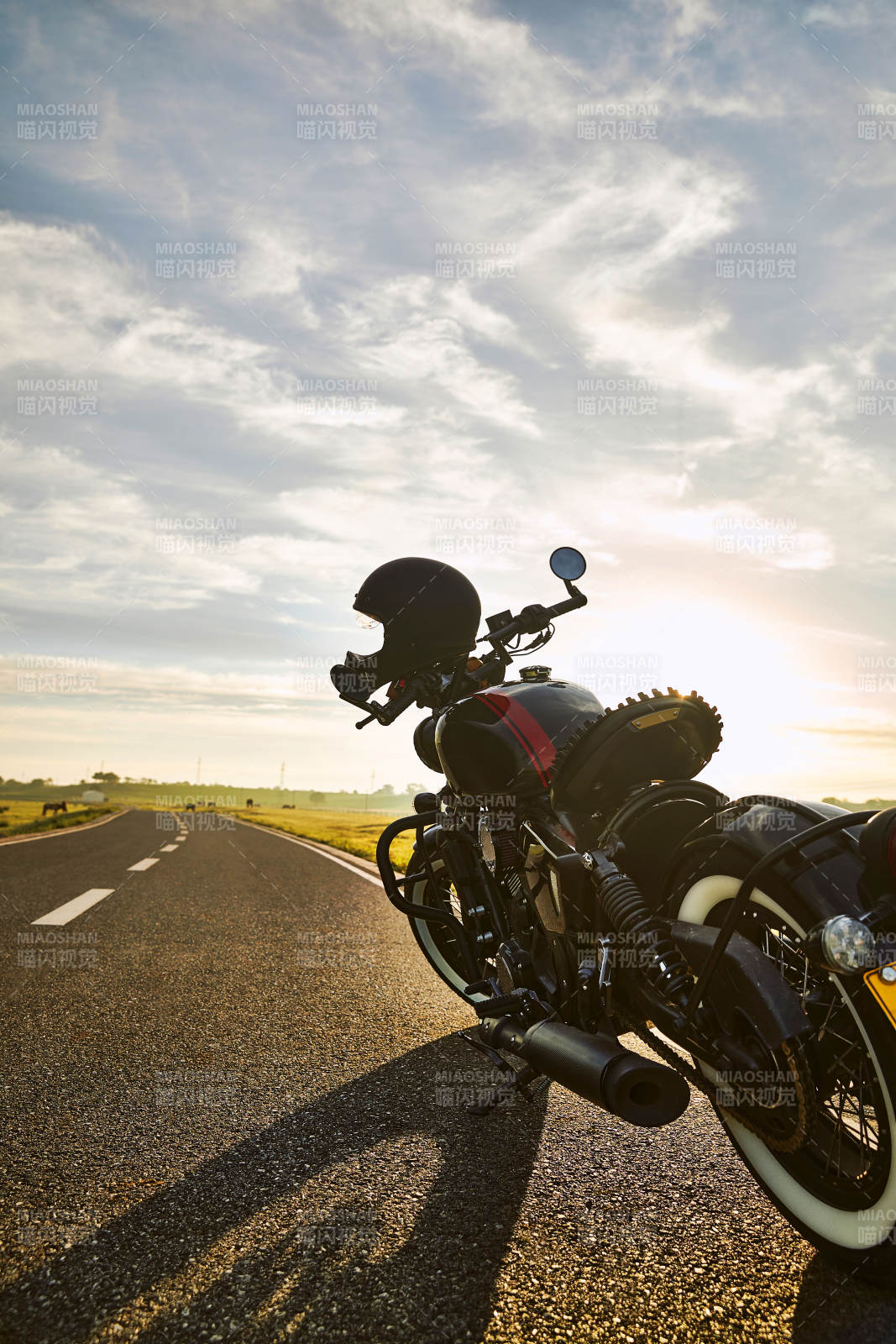 清晨朝阳下停靠在公路上的复古摩托车图片