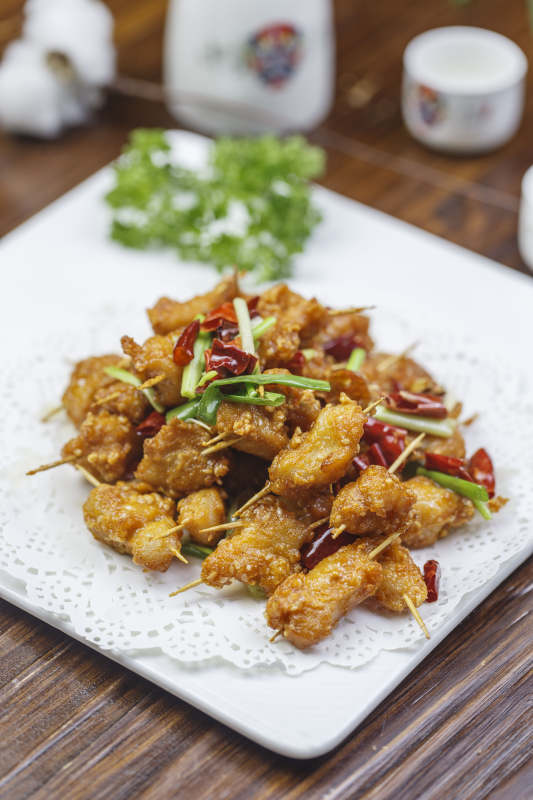 方形白色瓷盘装的香酥牙签肉图片