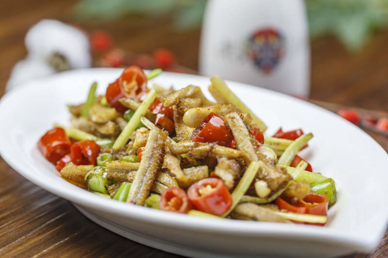 树叶形瓷盘装的湘味小炒鳝段图片