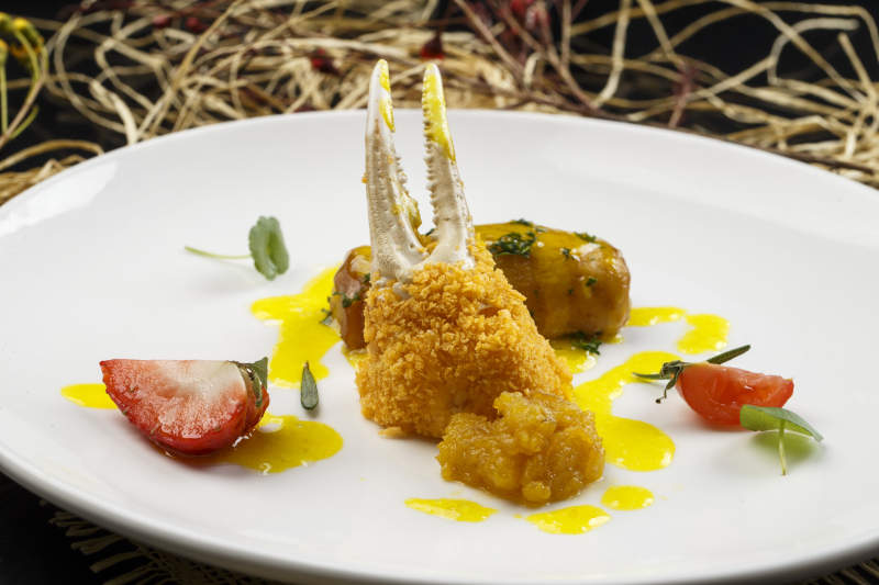 白色圆形瓷盘装的香炸深海蟹钳图片