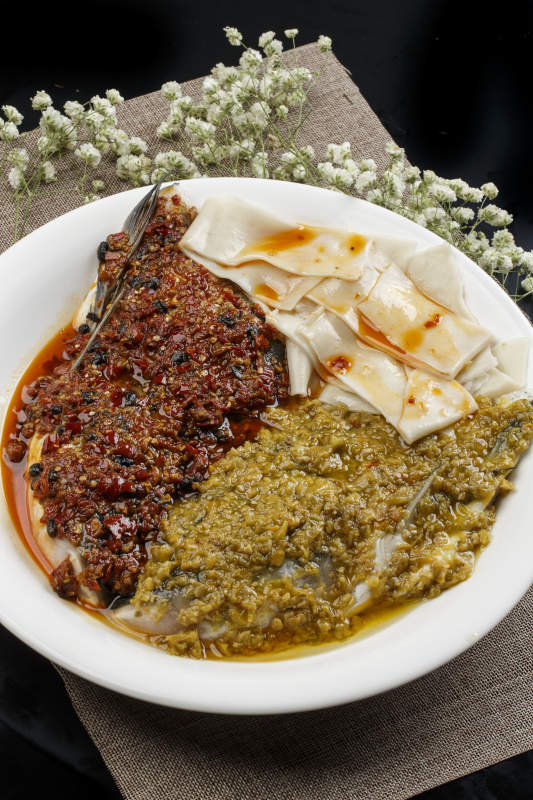 白色瓷盘装的双椒蒸鱼头盖面图片