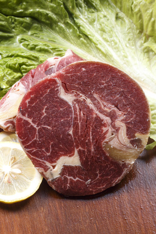 澳洲牛眼肉摆放在木质砧板上图片