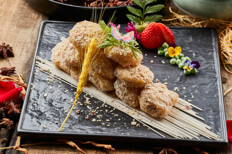 陈旧木板上的黑石盘装的麦香红豆泥茄盒图片