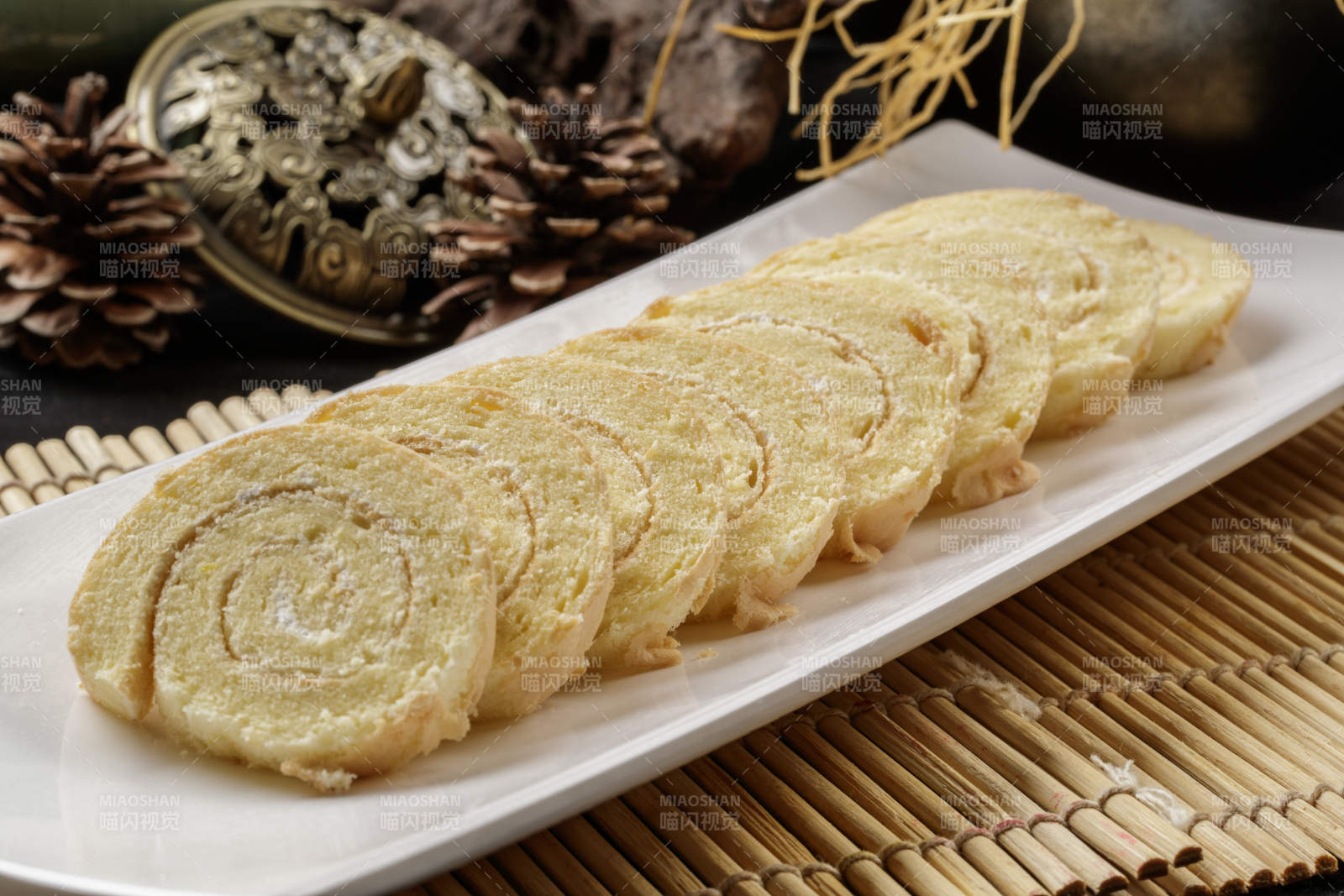 长瓷盘装的夹心奶油蛋糕卷图片