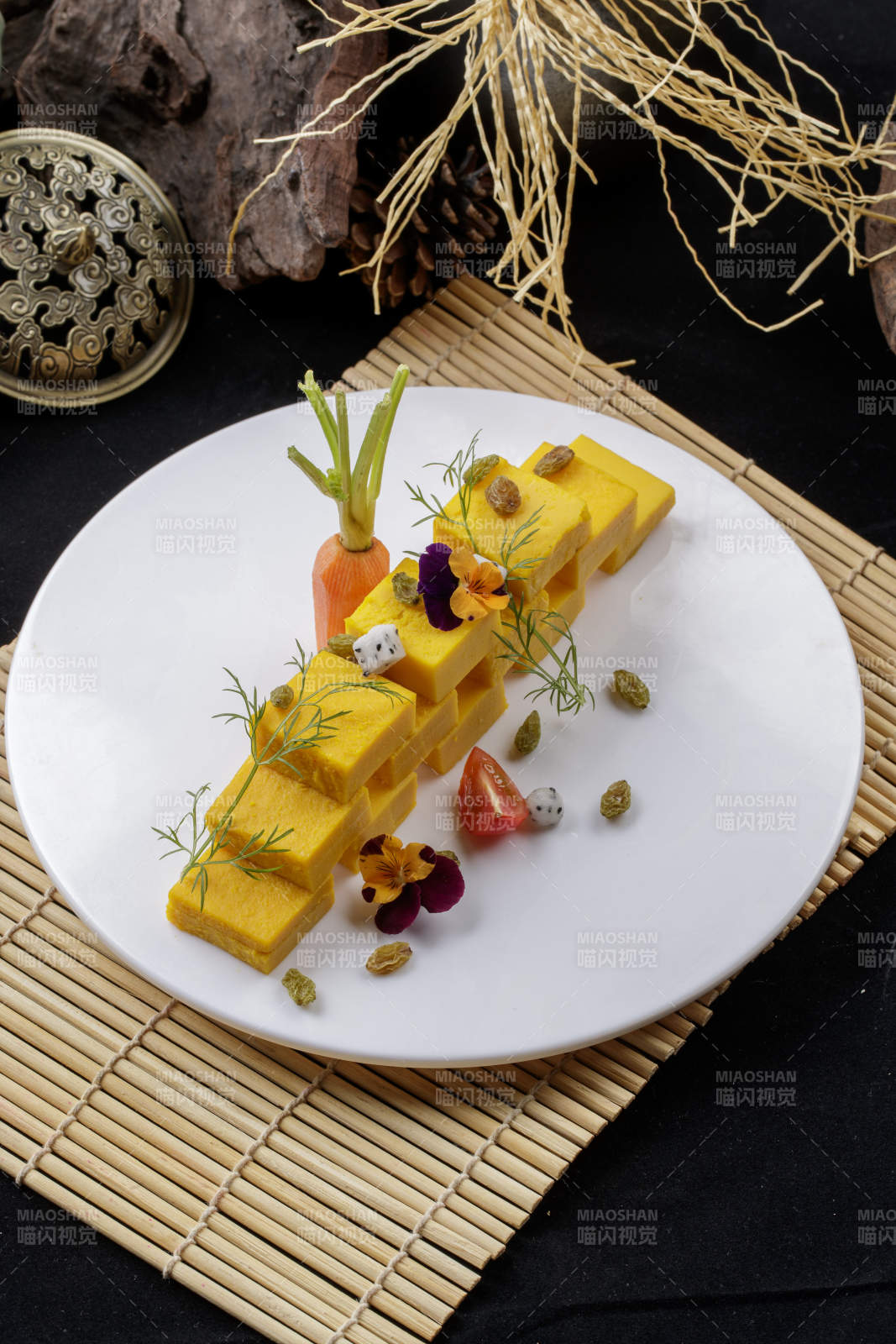 寿司帘上的圆瓷盘装的豌豆黄图片