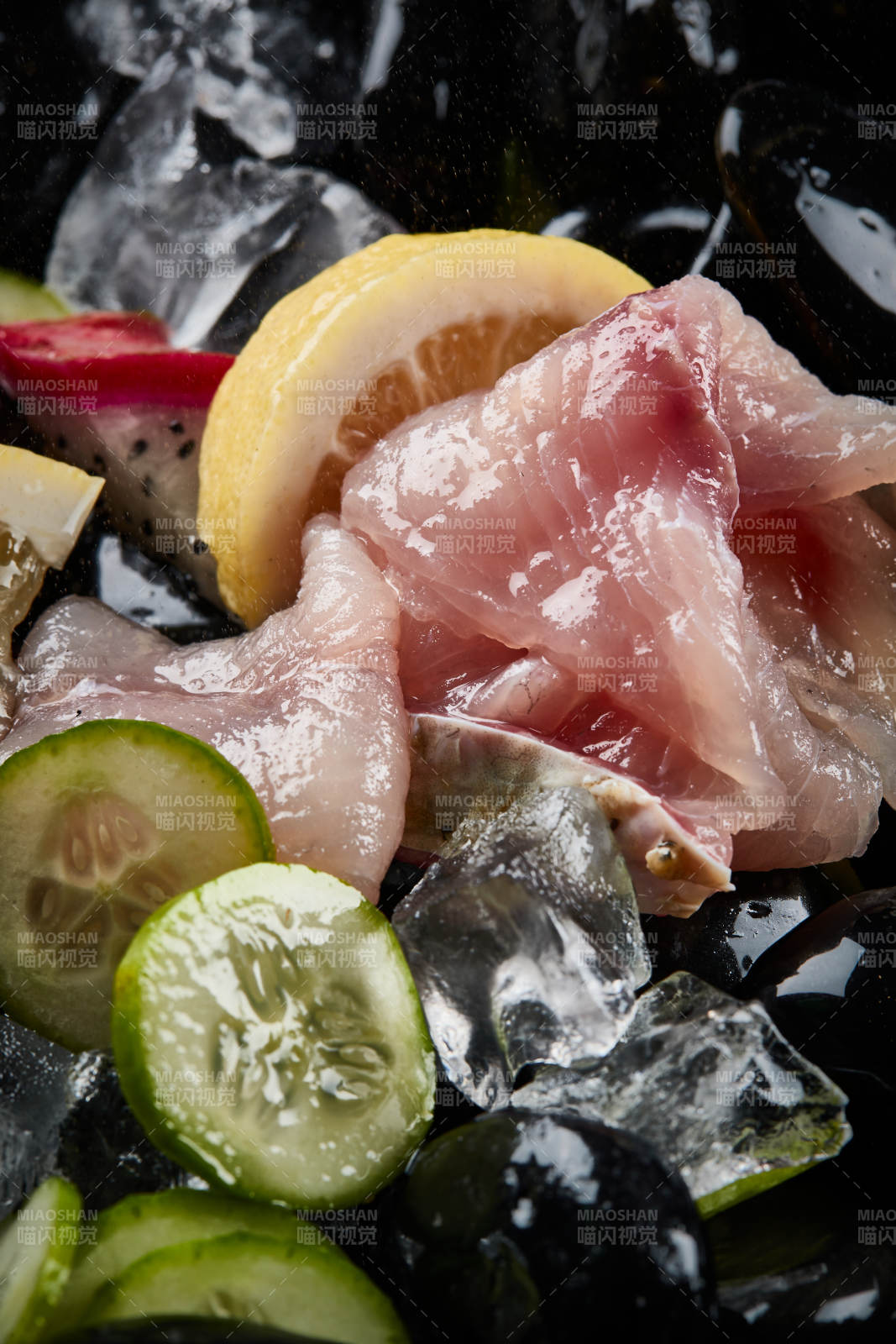 将晶莹白润的鲜鱼片码放在黑色的圆瓷盘上图片