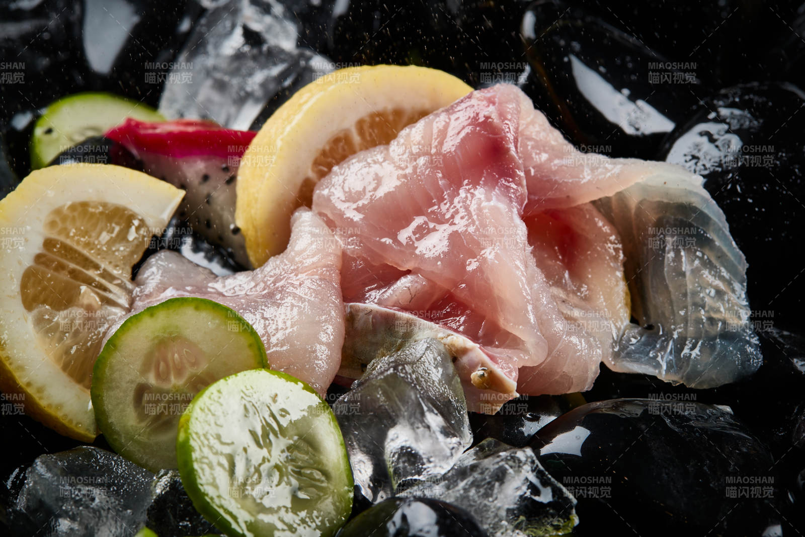 将晶莹白润的鲜鱼片码放在黑色的圆瓷盘上图片