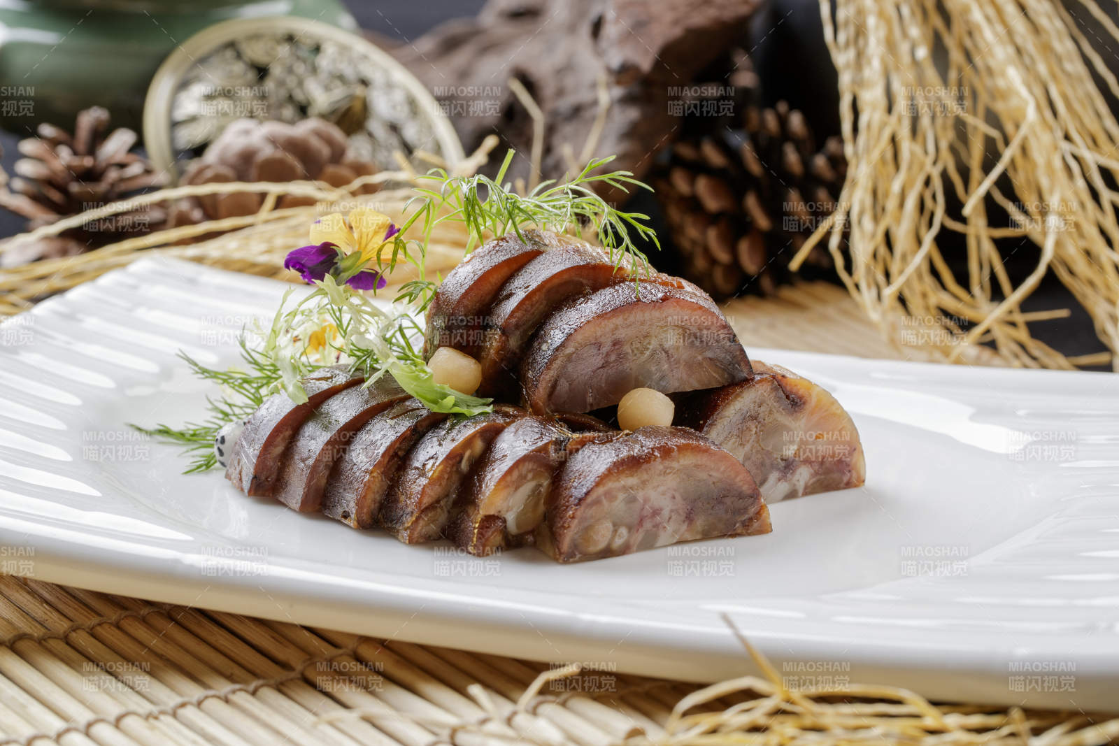 寿司帘上的长瓷盘装的熏肘花图片