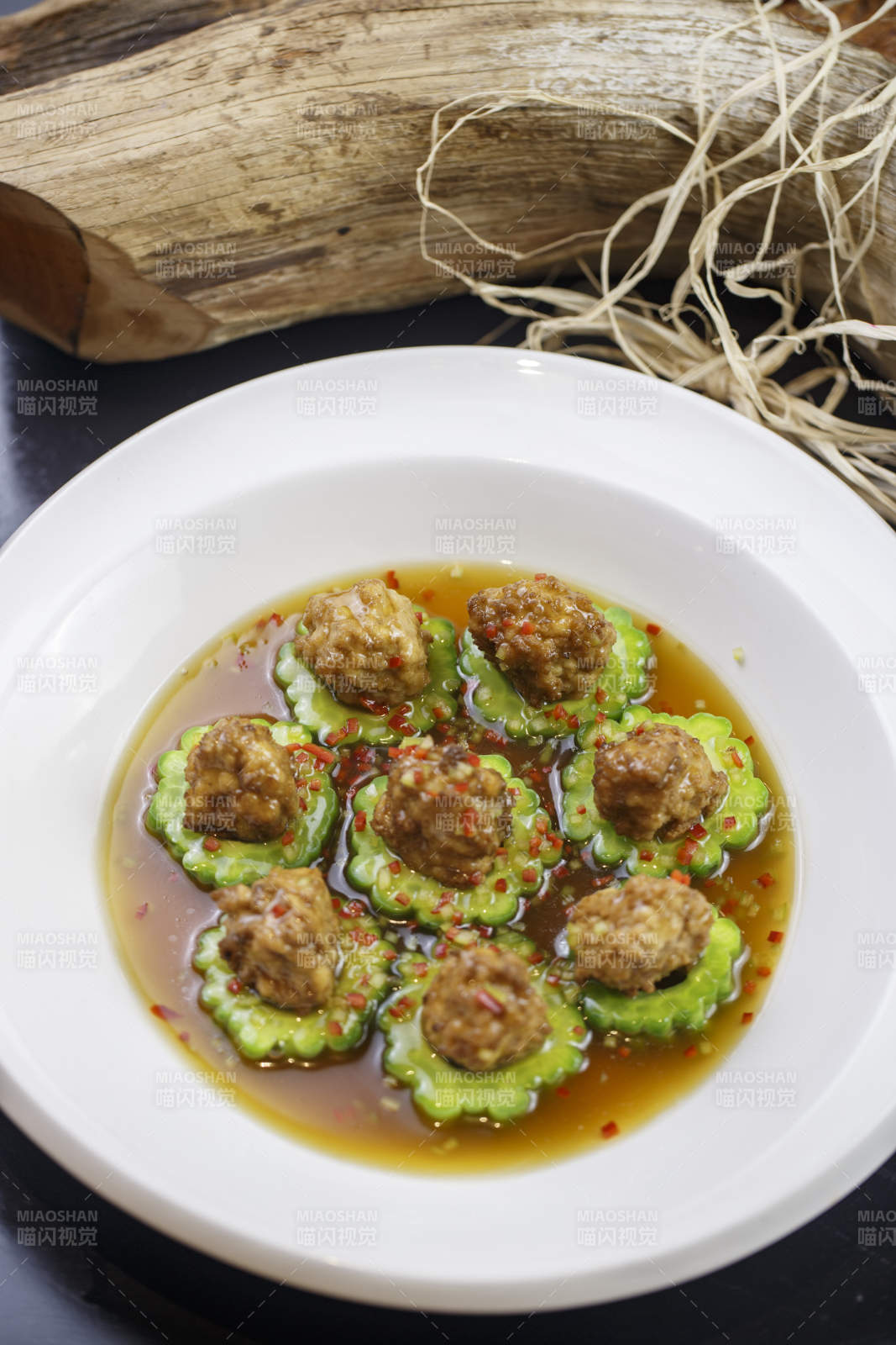 圆形白瓷盘装的苦瓜豆腐酿图片