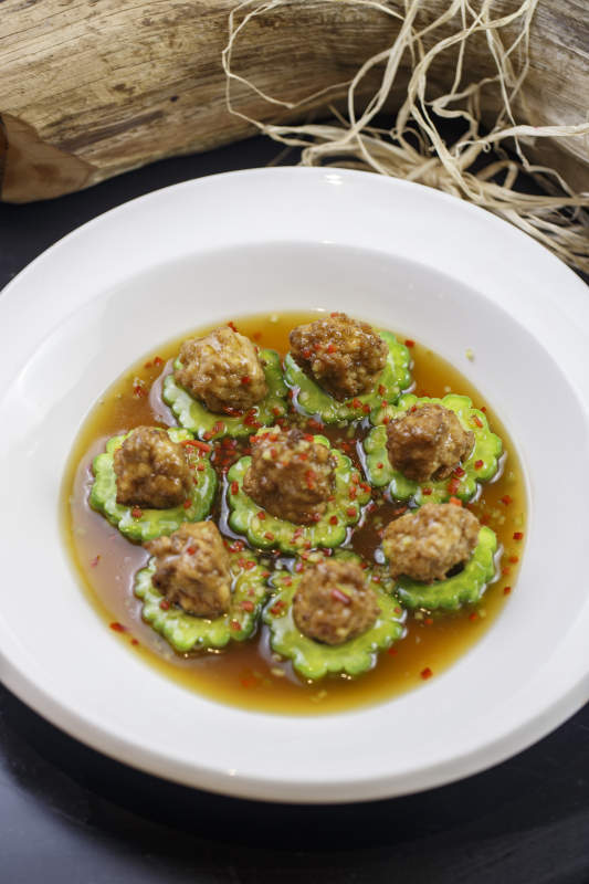 圆形白瓷盘装的苦瓜豆腐酿图片