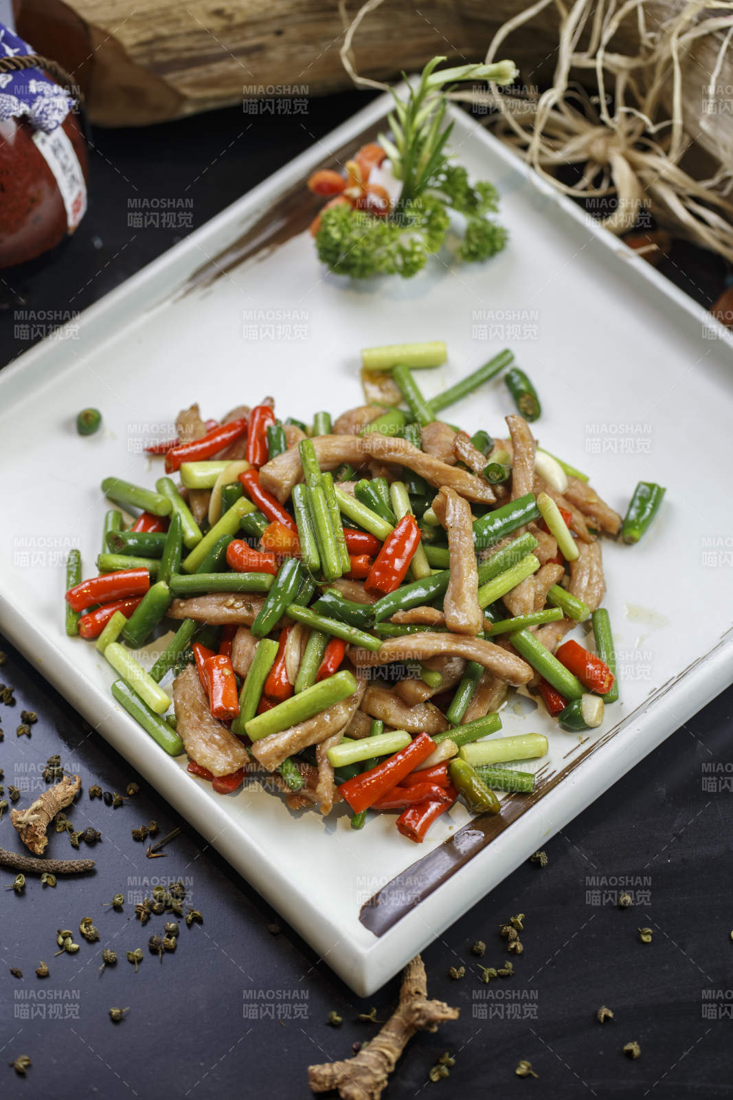 方形白瓷盘装的香辣蒜薹小炒肉图片