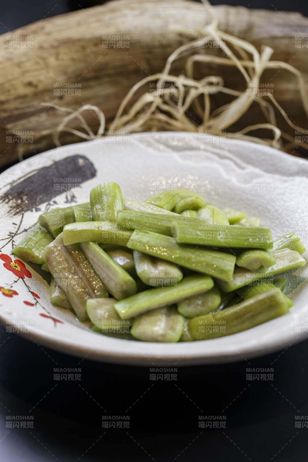 梅花图案的瓷盘装的炝炒丝瓜图片