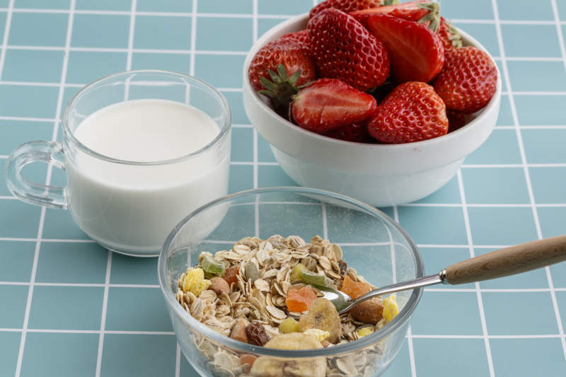 自制的水果坚果混合燕麦铺洒摆放在桌子上图片