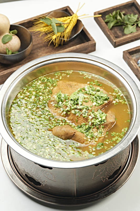 铜锅餐具装的葱香炖煮柴鸡汤图片