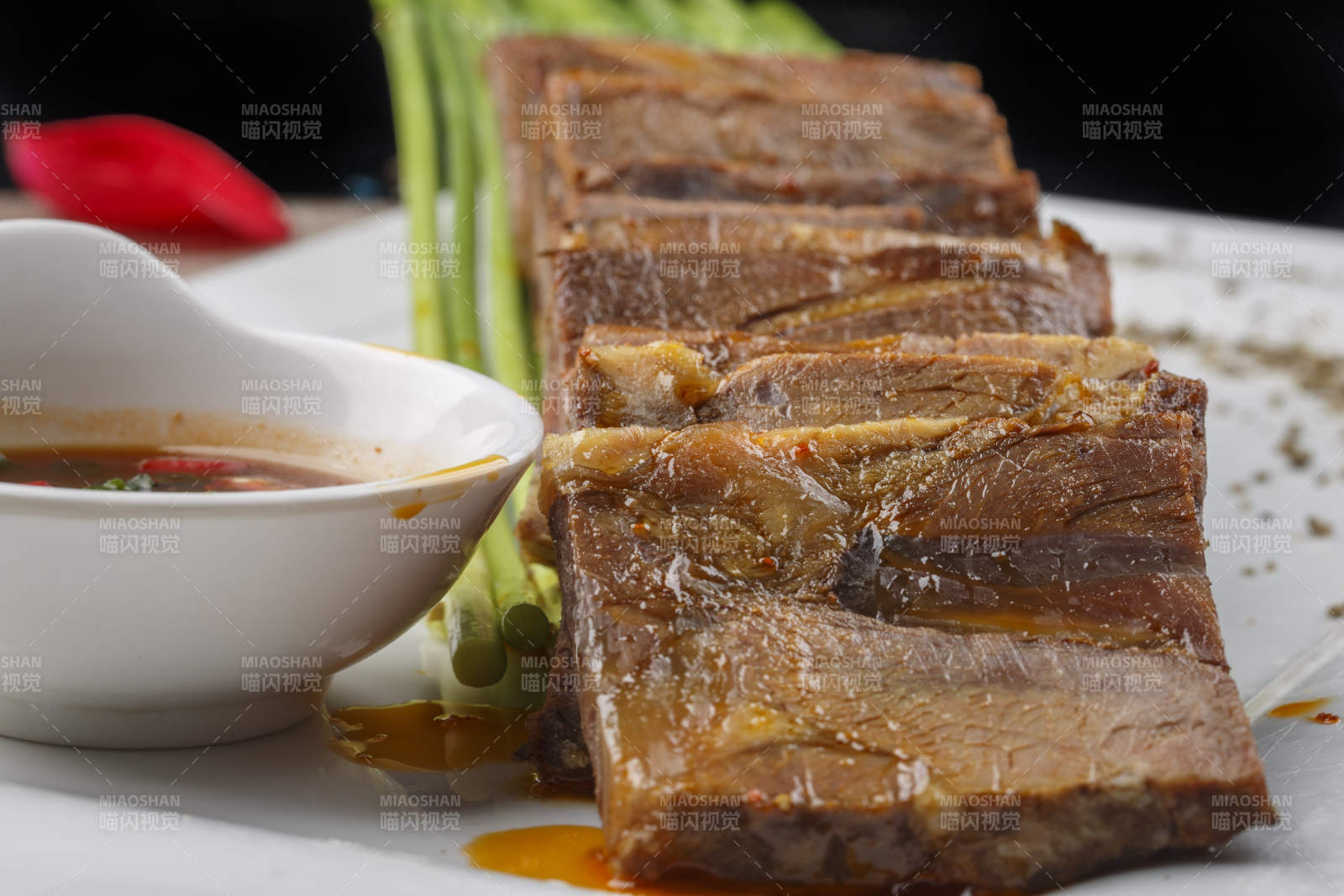 白色瓷盘装的香辣蘸汁牛瓜条图片