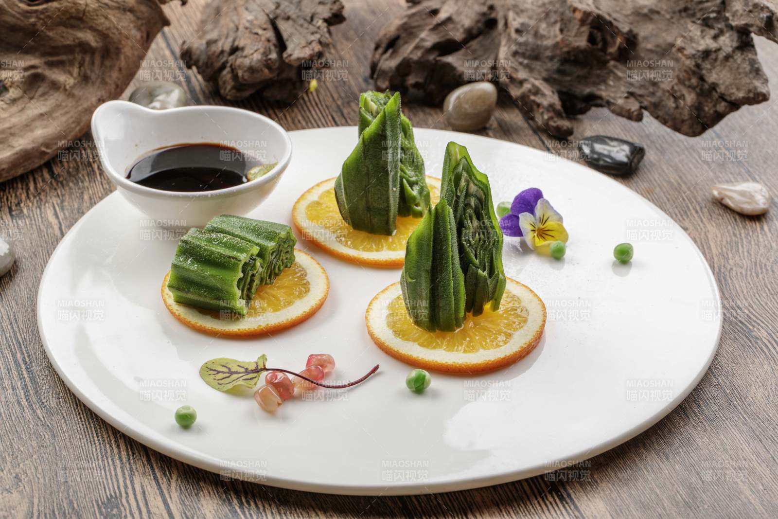 瓷盘装的甜橙凉拌秋葵图片