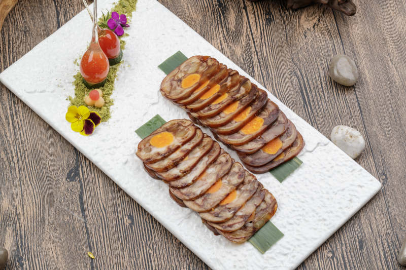 白色瓷盘装的猪耳鱿鱼蛋黄卷图片