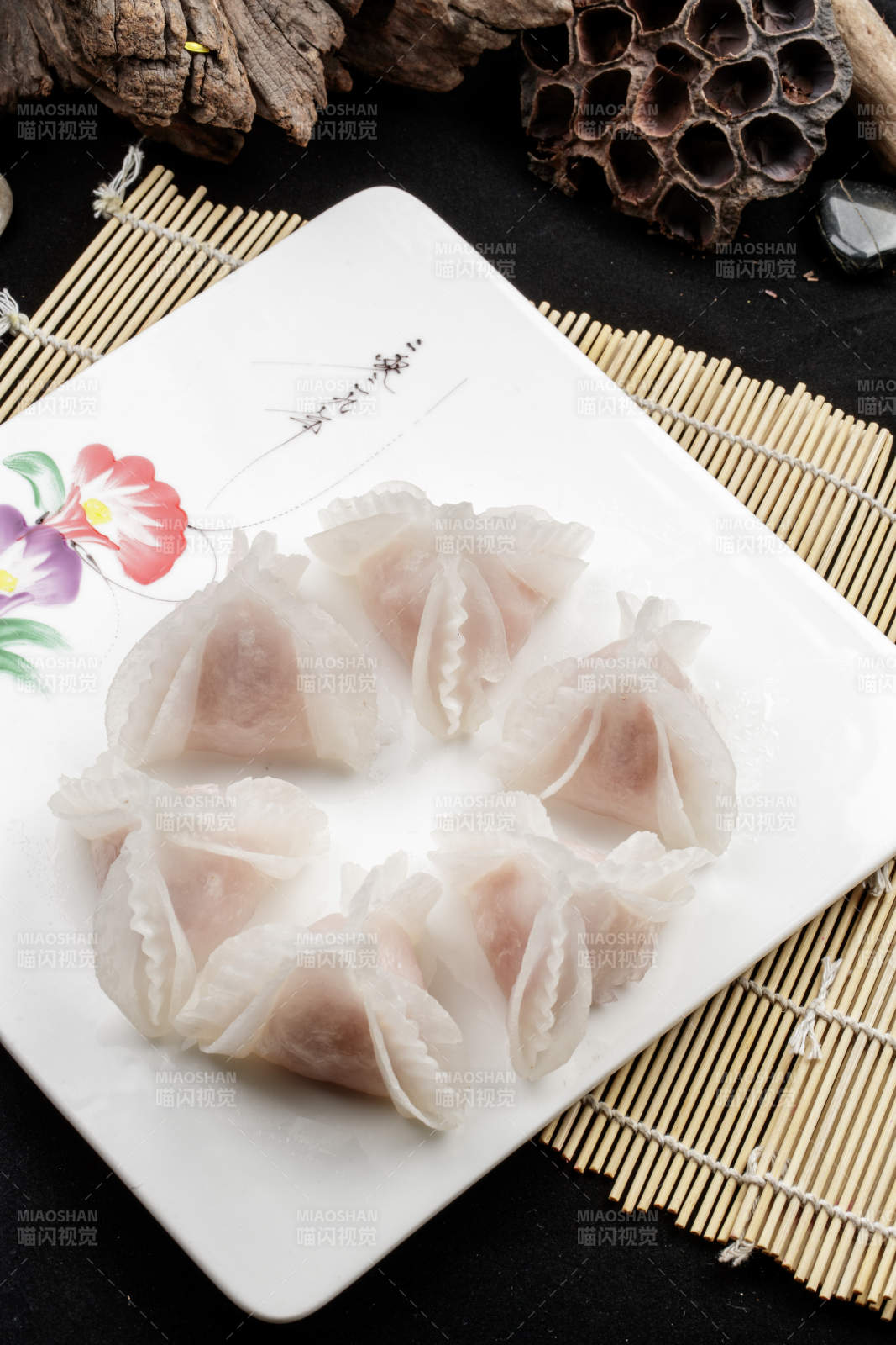 白色瓷盘装的蒸猪肉鲜蒸虾饺图片