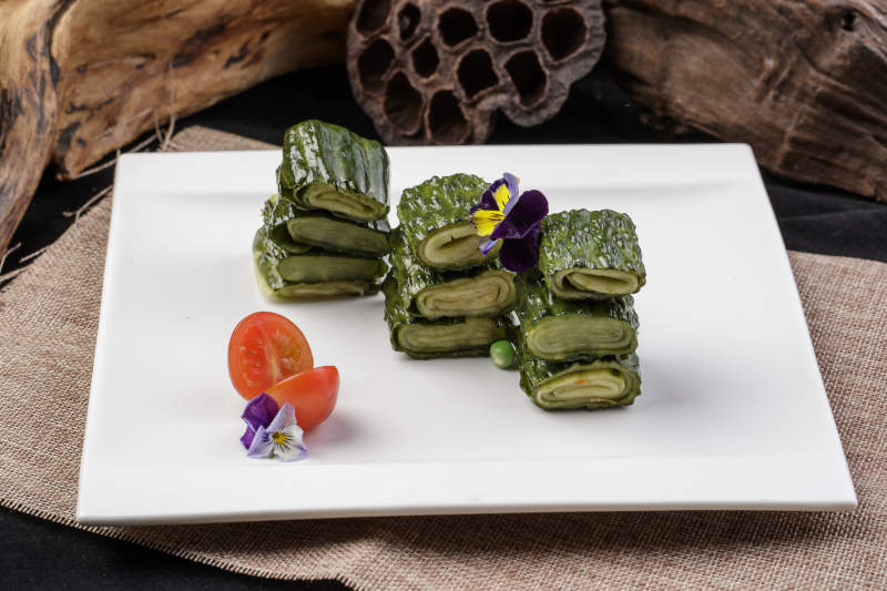 白色瓷盘装的美味酱黄瓜卷图片