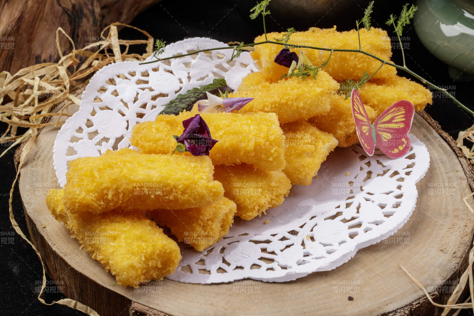 金黄酥脆的油炸银鳕鱼摆放在樟木砧板上图片