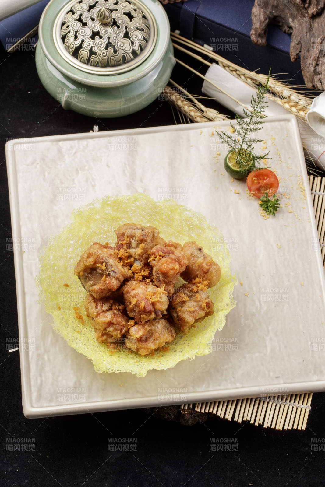 米色放瓷盘装的金盏猪小排摆放在寿司帘上图片