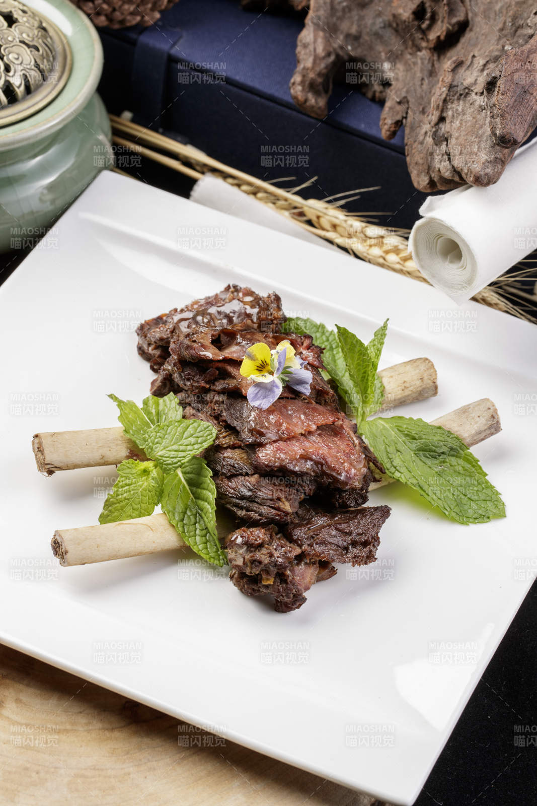 方形瓷盘装的脱骨酱牛肋摆放在樟木砧板上图片