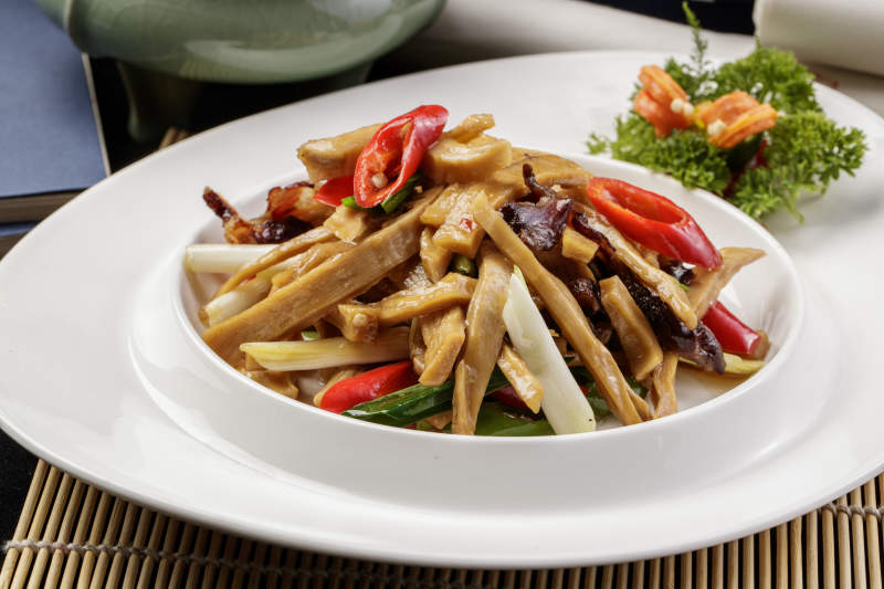 白色瓷盘装的的大葱烧猪肚图片