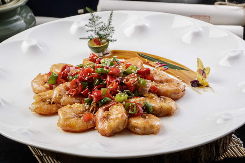 米椒开背芙蓉虾摆放在黑色背景上图片