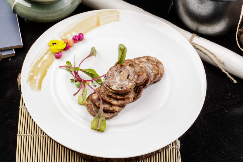 白色瓷盘装的五香牛腱切片图片