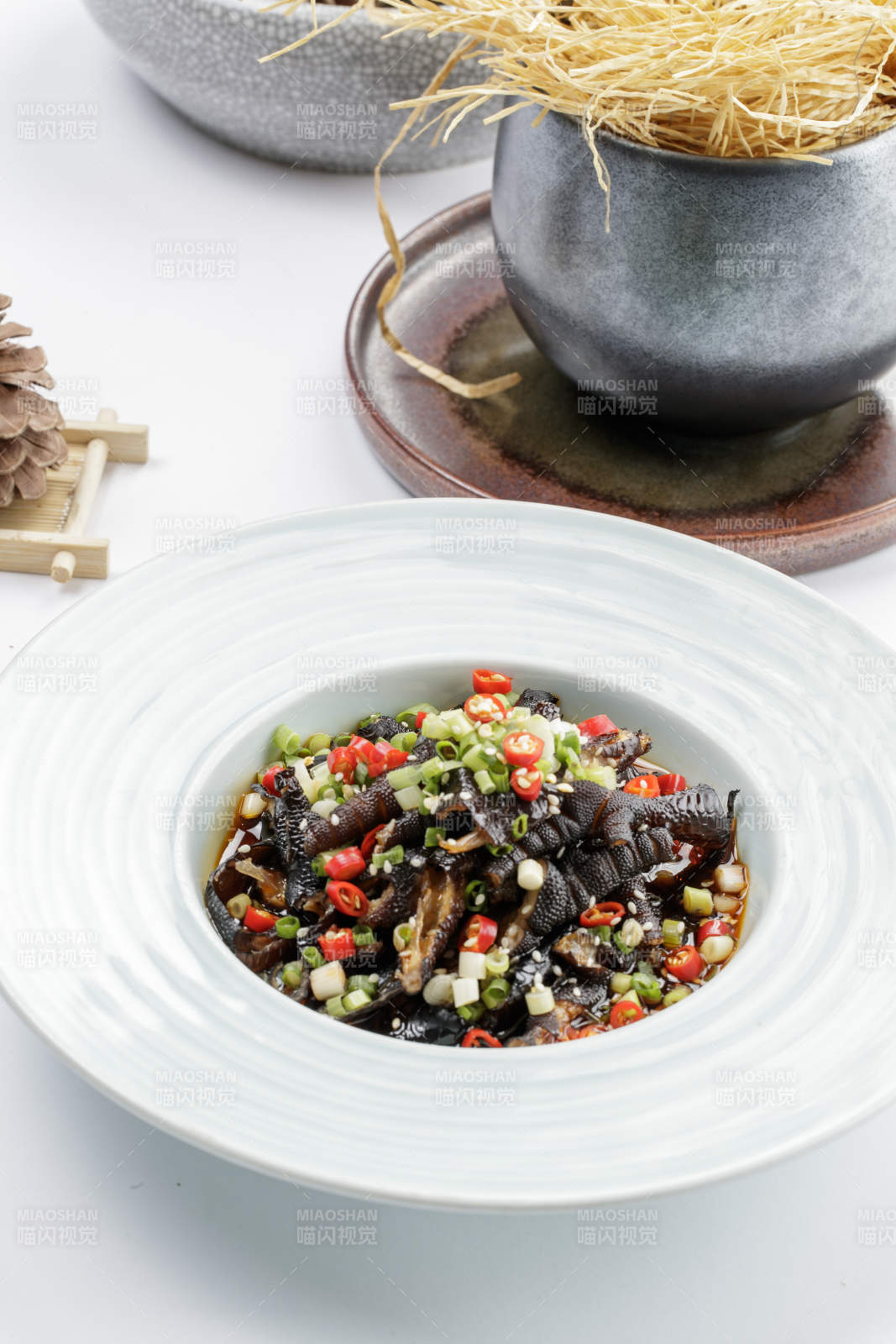 白色瓷盘装的米椒蒜香乌鸡脚图片