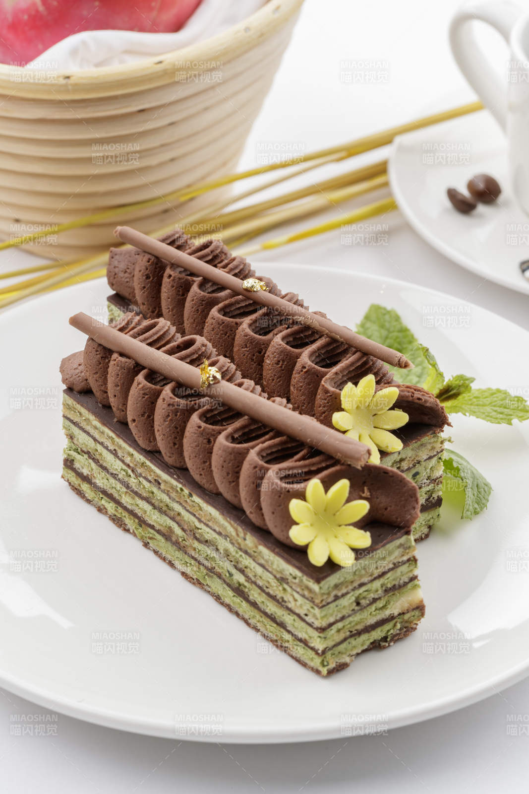 巧克力酱抹茶奶酪慕斯蛋糕摆放在白色背景上图片