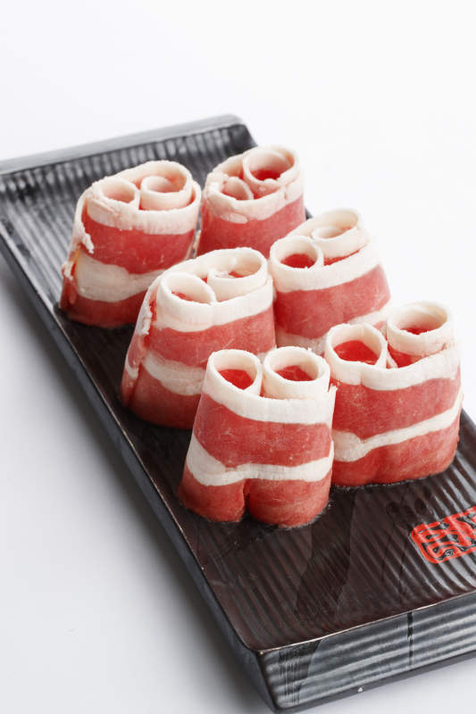 长方形黑色瓷盘装的羊五花卷图片