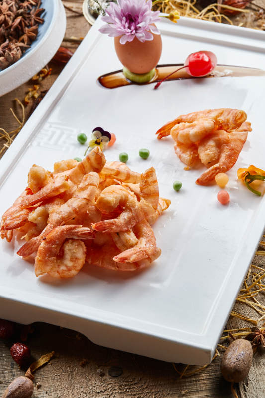 黑色瓷盘装的避风塘炸虾图片