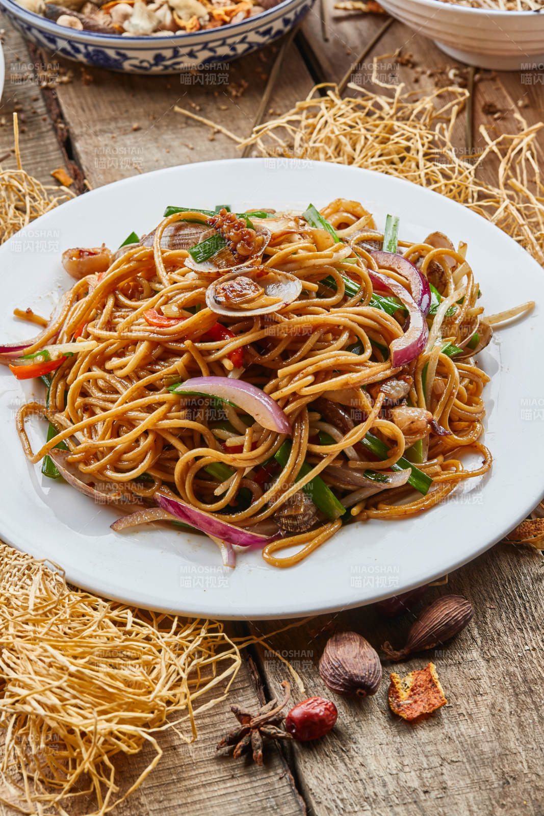 青瓷盘装的海鲜炒意大利面图片