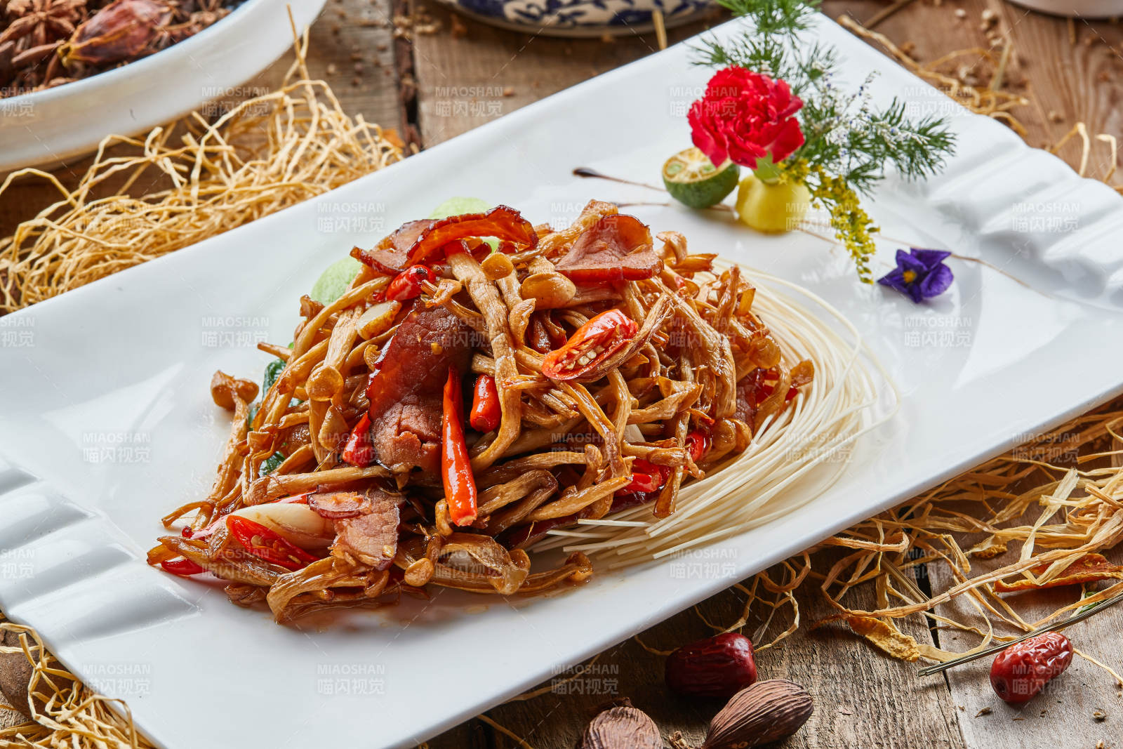 白色瓷盘的茶树菇蒜香炒腊肉图片