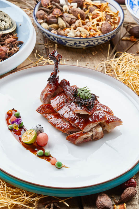 双色瓷盘装的烧腊鹅腿图片