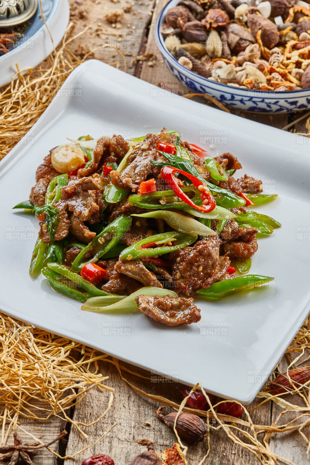 方青瓷盘装的蒜香辣炒牛柳图片