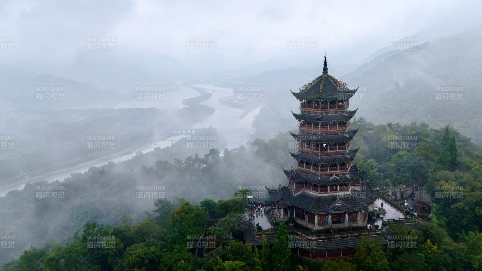 雾中古塔山河景图片