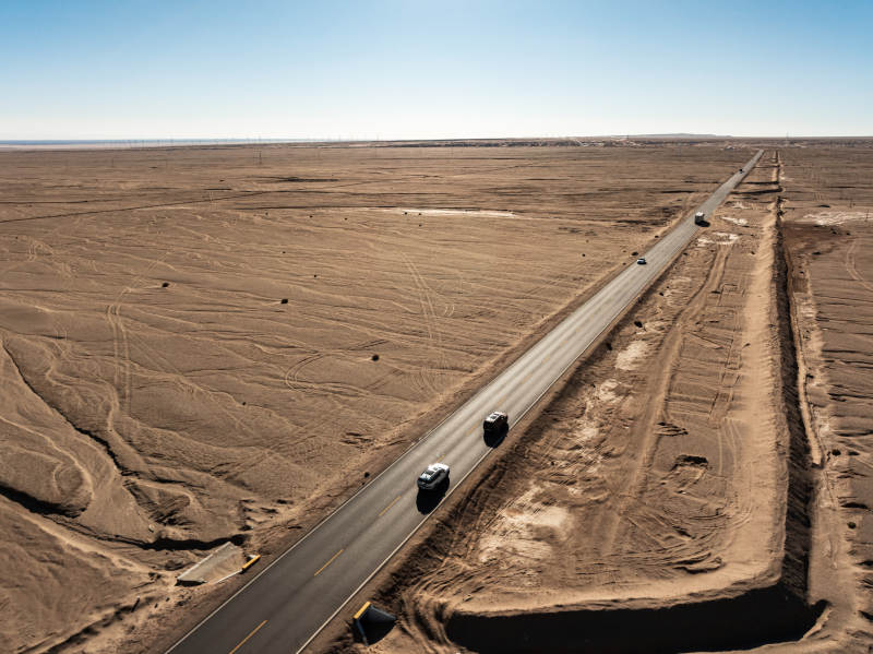 汽车行驶在西北戈壁荒漠笔直公路延伸远方图片