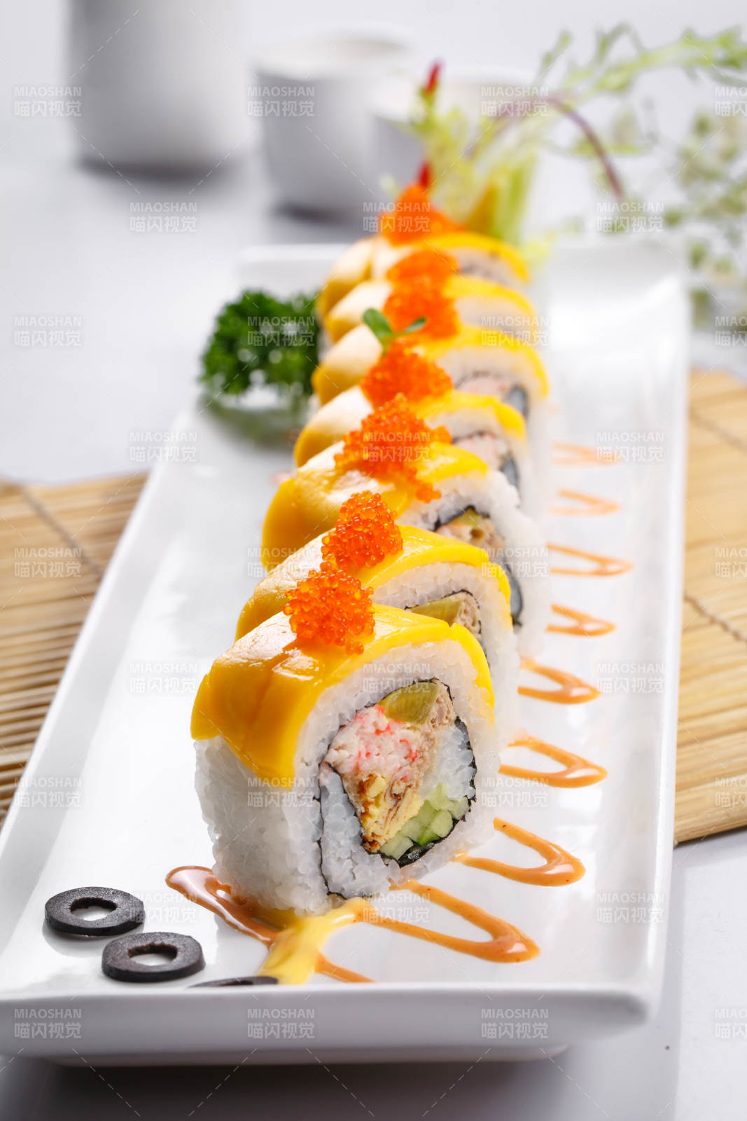 黄金甲蟹子寿司卷摆放在寿司帘上图片