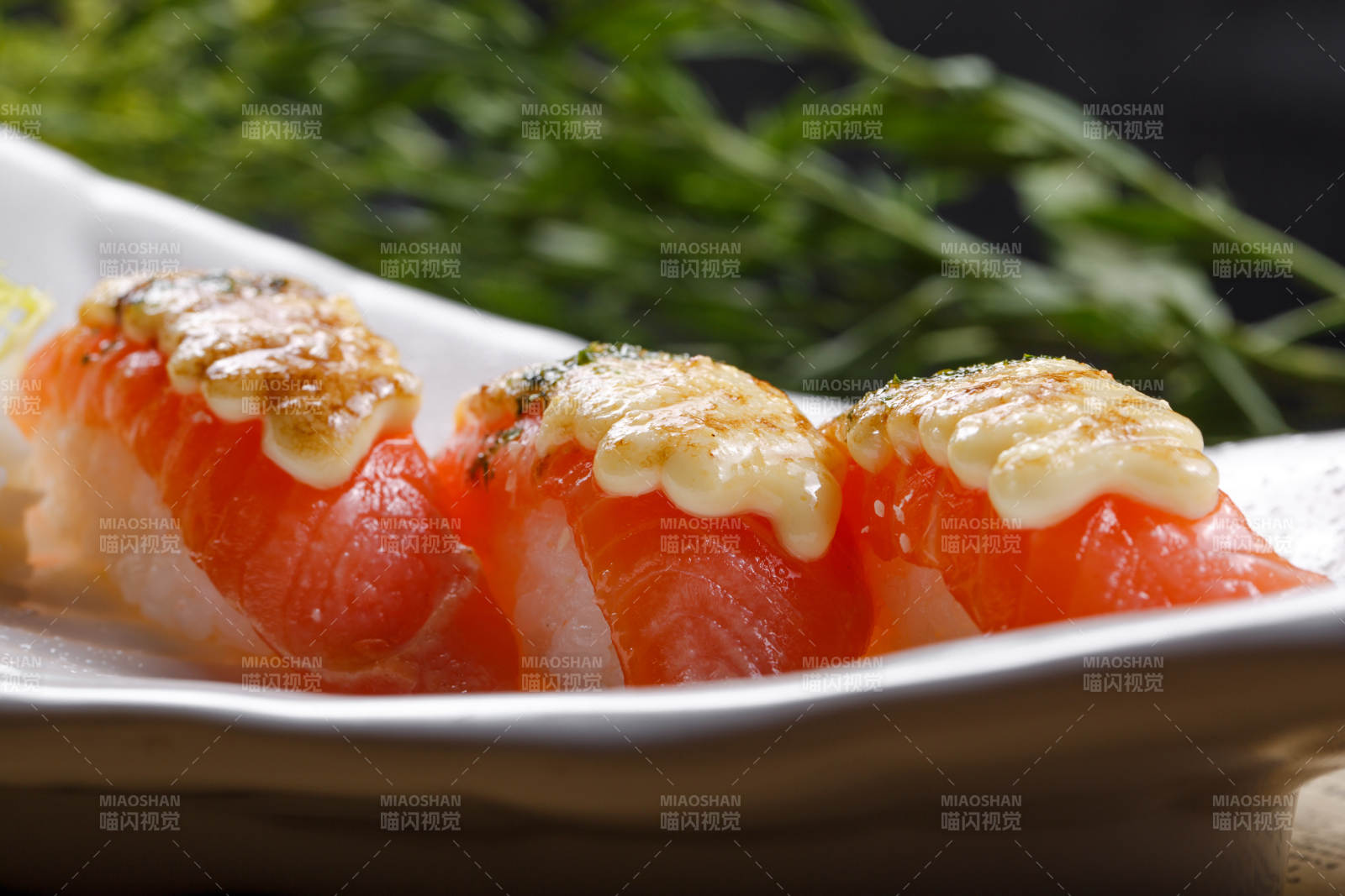 芝士焗三文鱼手握寿司摆放在英文包装纸上图片