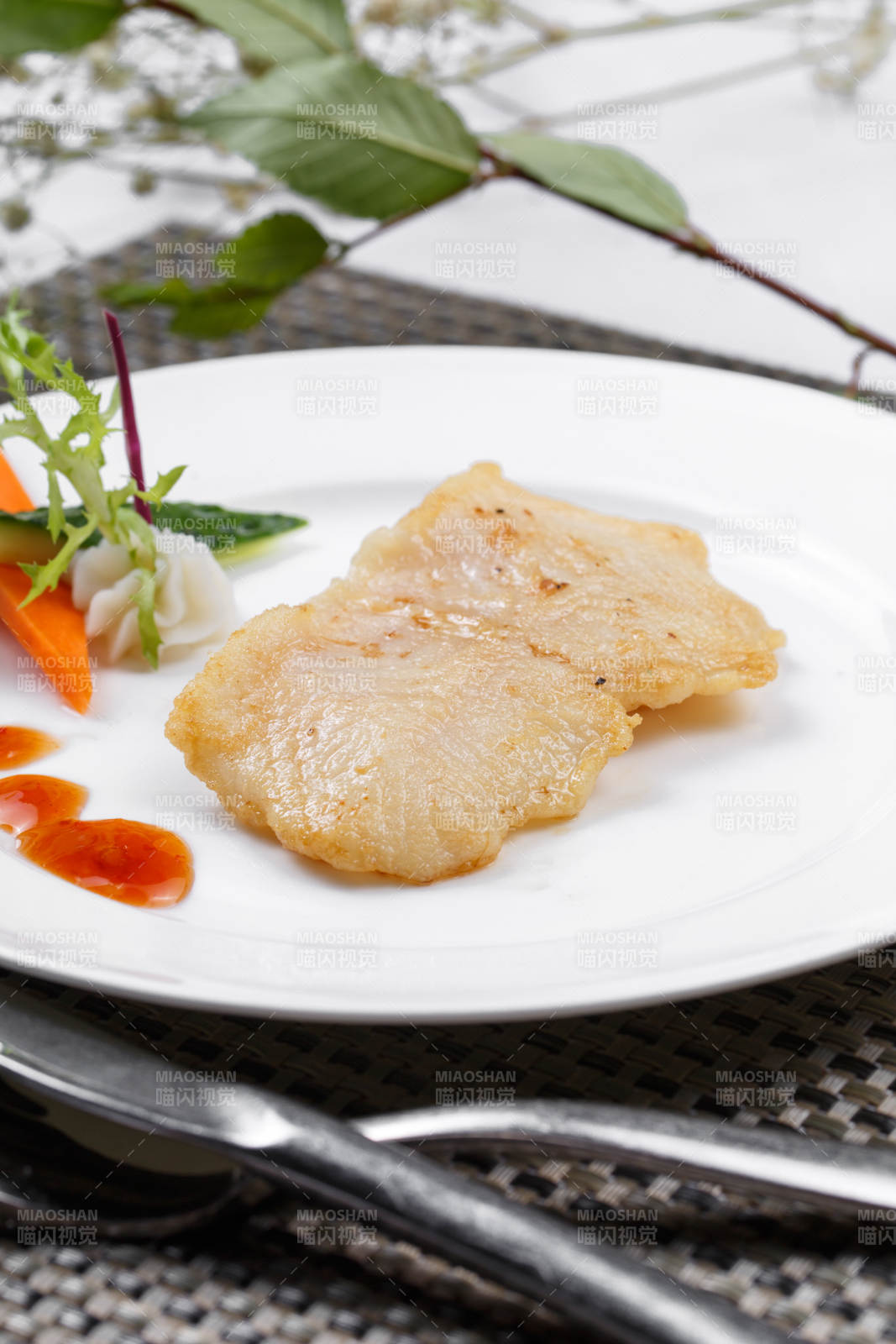 日式铁板煎石斑鱼摆放在餐垫上图片