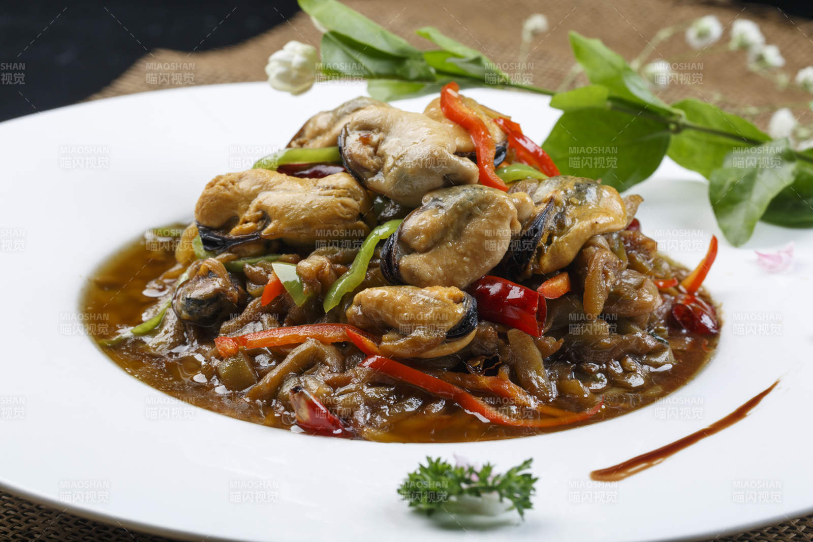 圆形磁盘装的酱爆生蚝图片