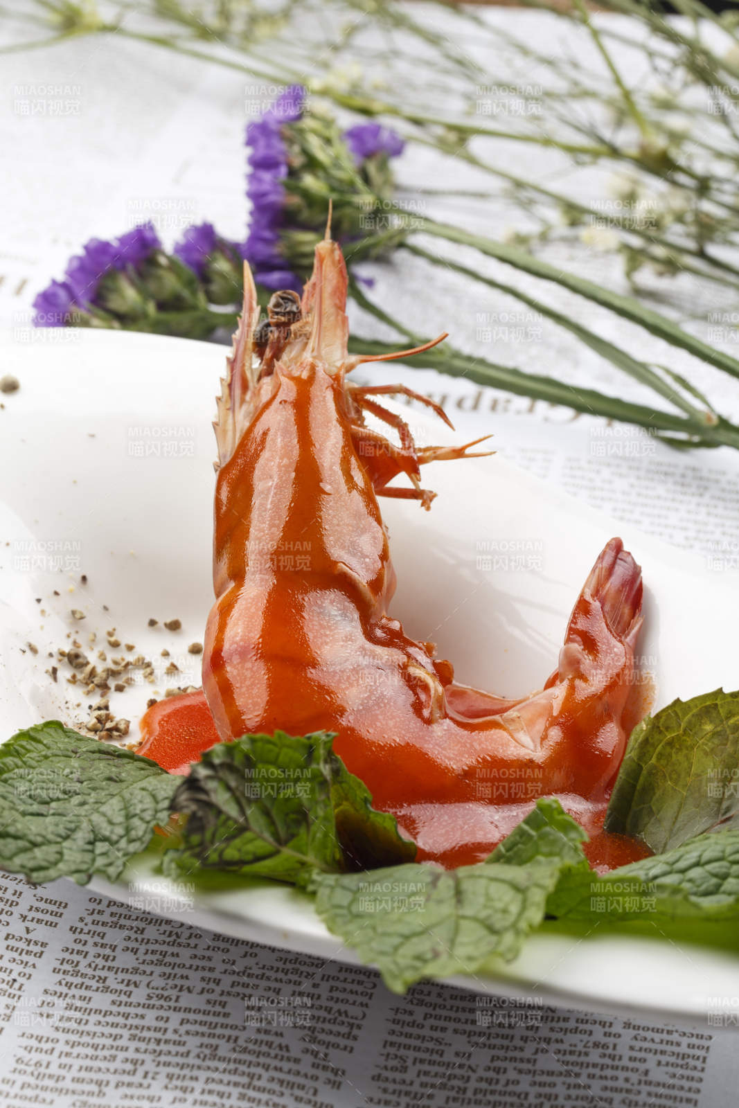 白色椭圆瓷盘装的浇汁大明虾图片