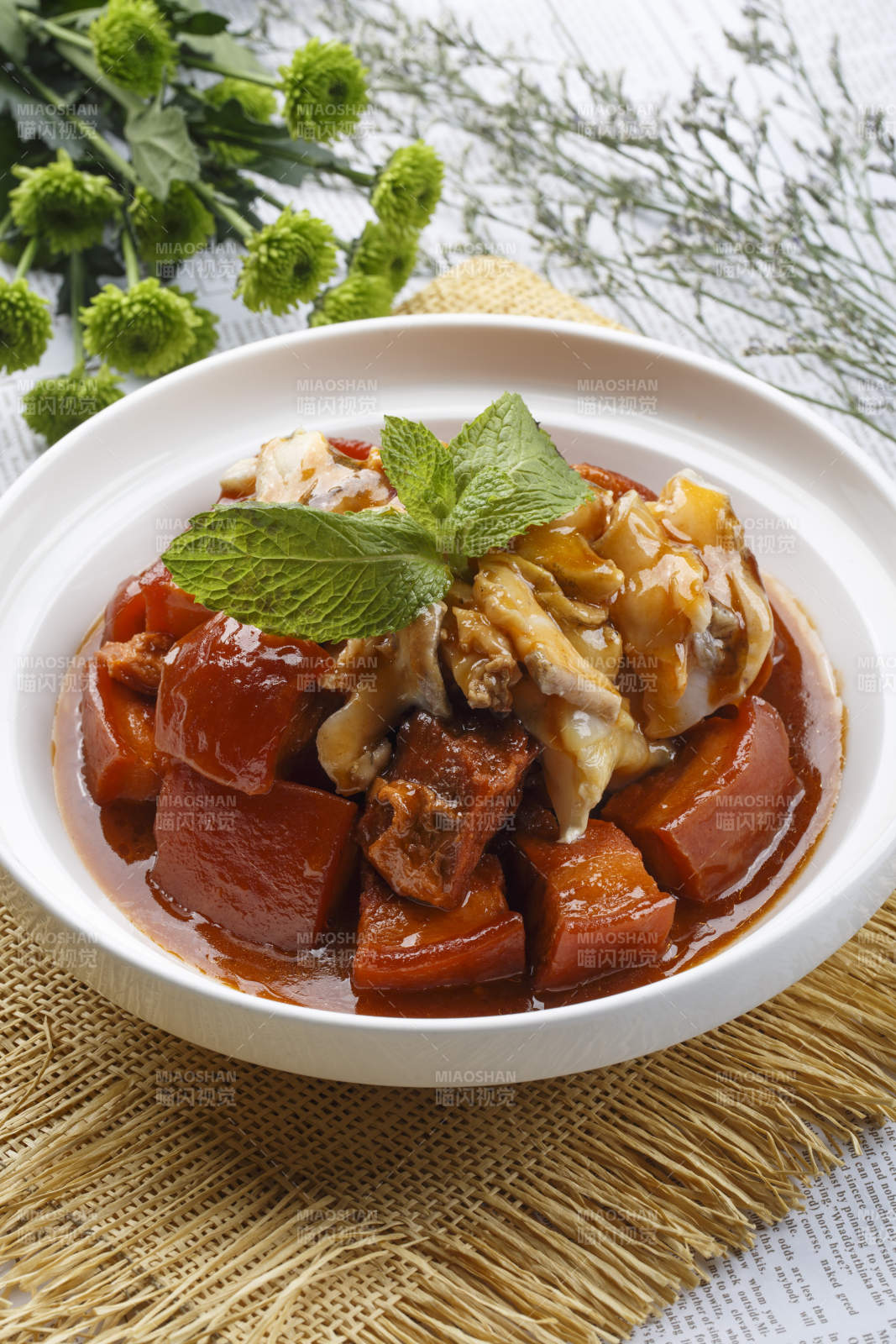 白色圆盘装的红烧肉焖海鲜螺片图片