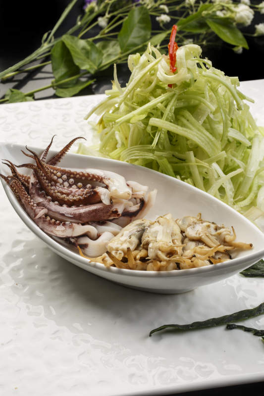 白色方形瓷盘装的西芹拌海鲜图片