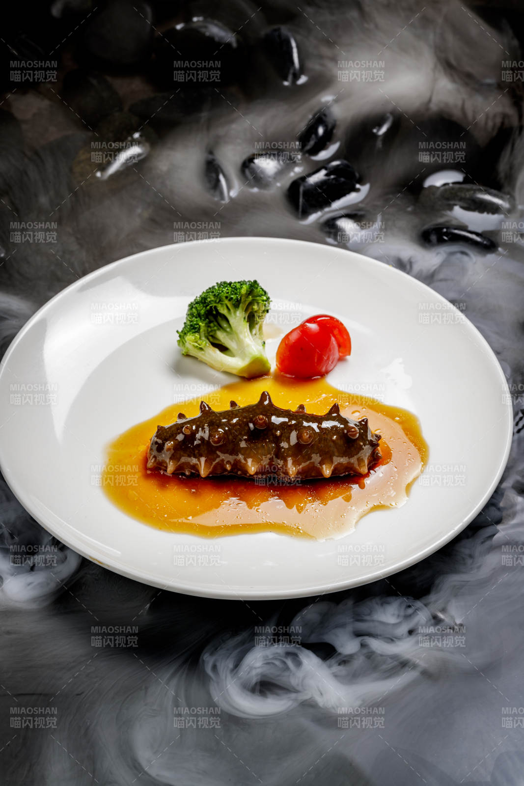 鲍汁扣辽参摆放在干冰缭绕的水中图片